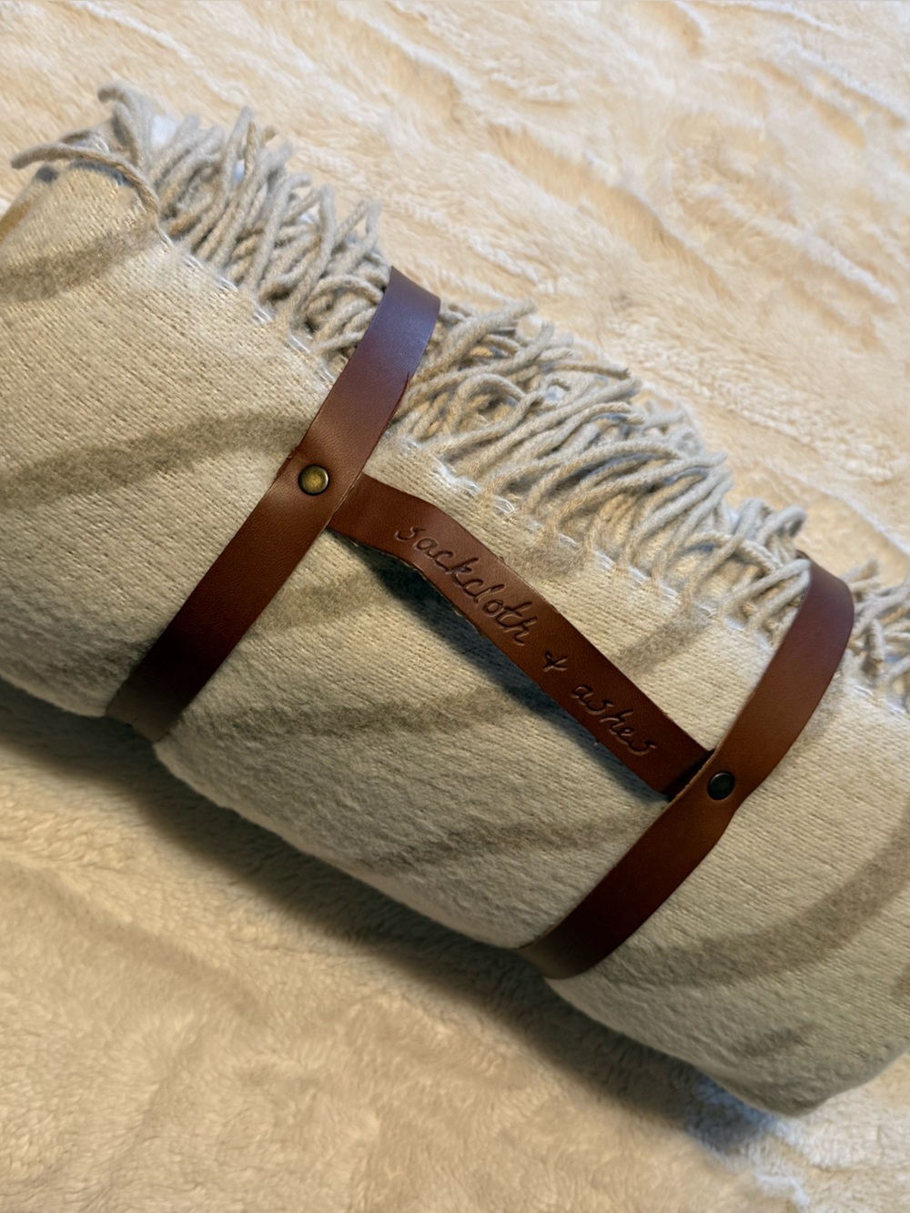 National Geographic Cream Throw Blanket with Brown Leather Strap